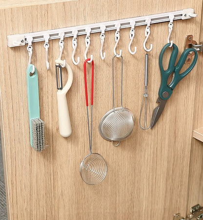 Sliding hook rail for wardrobes