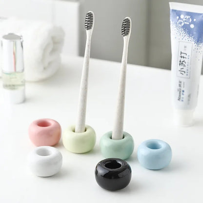 Ceramic toothbrush holder with a stable base