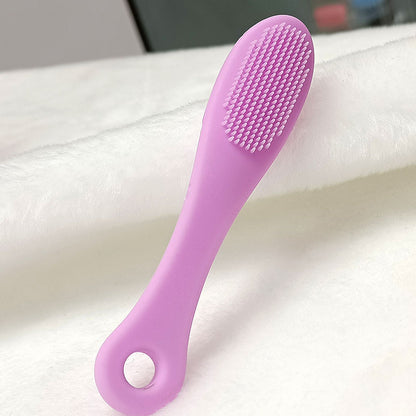 Face cleansing finger brush in purple