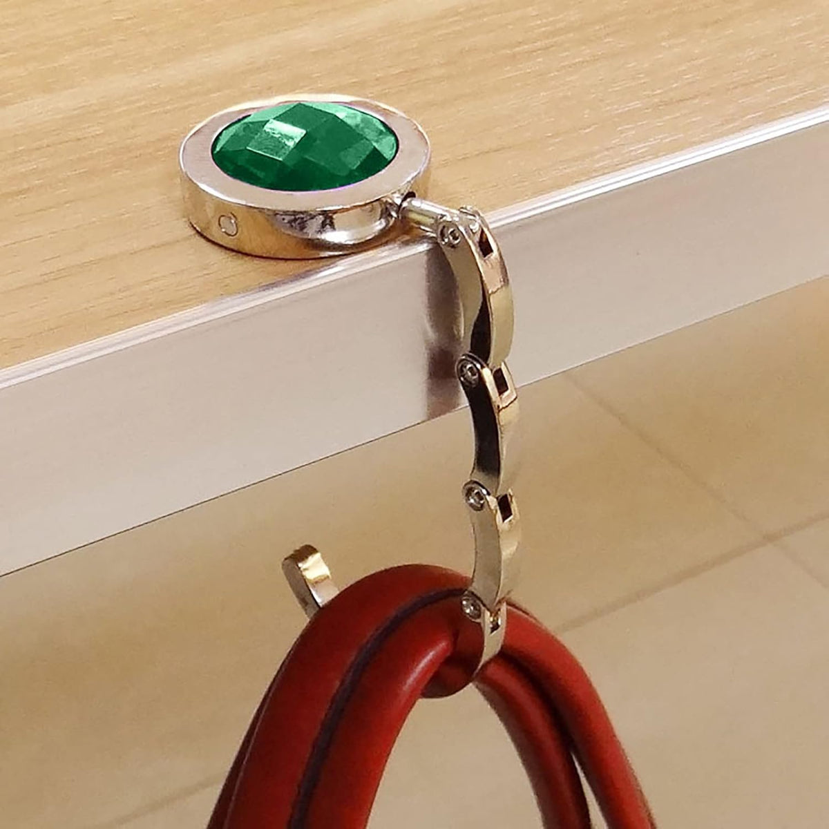 Foldable handbag holder that hangs your purse on a table