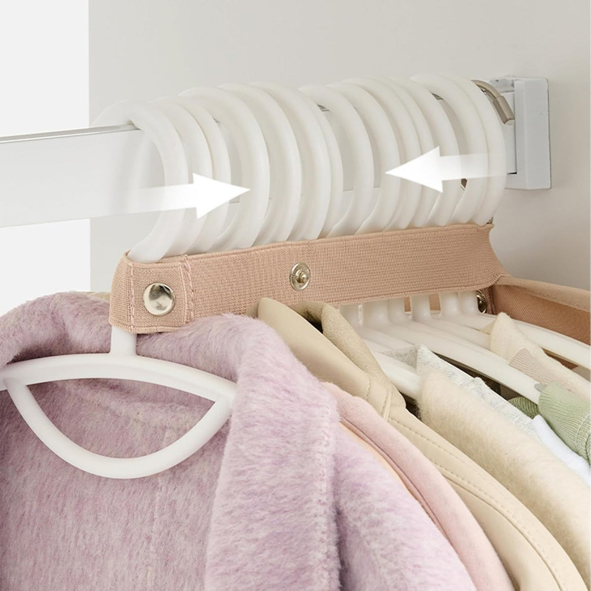 Hanging clothes compression organizer top strap gathering the hangers together on the closet rail
