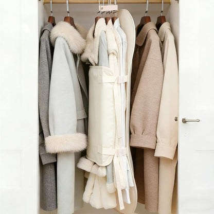 Hanging clothes compression organizer storing bulky winter coats among other jackets in a wardrobe