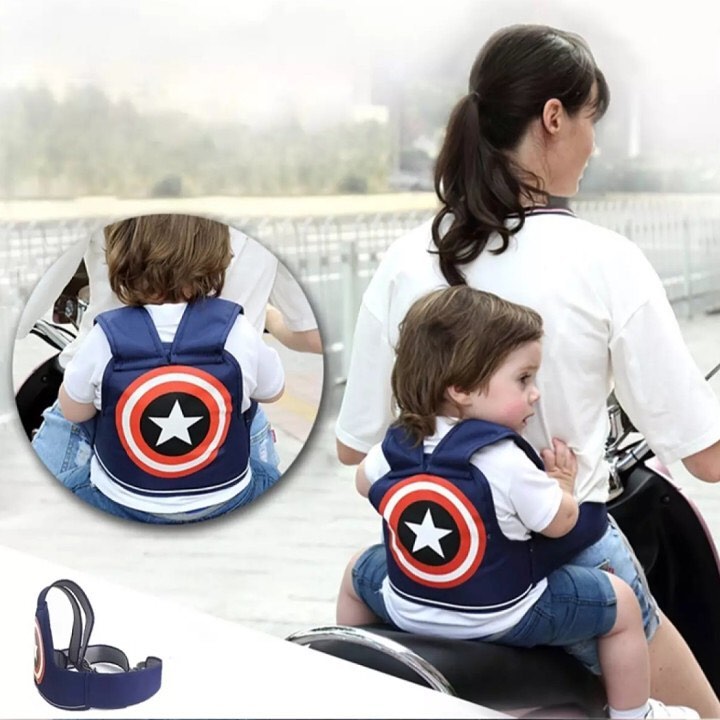 Motorcycle child safety harness that attaches to the rider