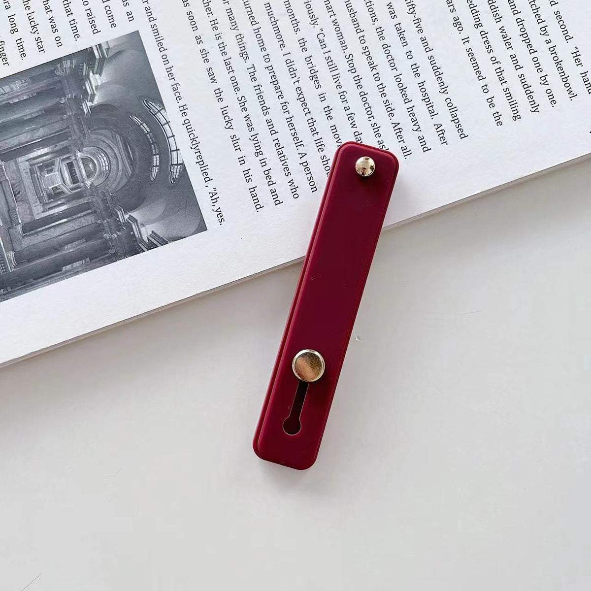 Phone grip strap holder in dark red