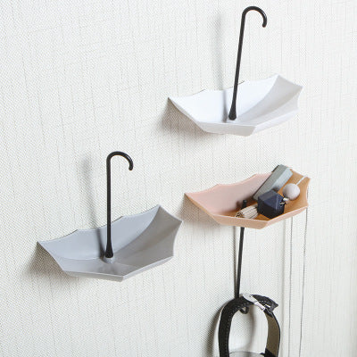 Self-adhesive umbrella hooks that stick to many surfaces