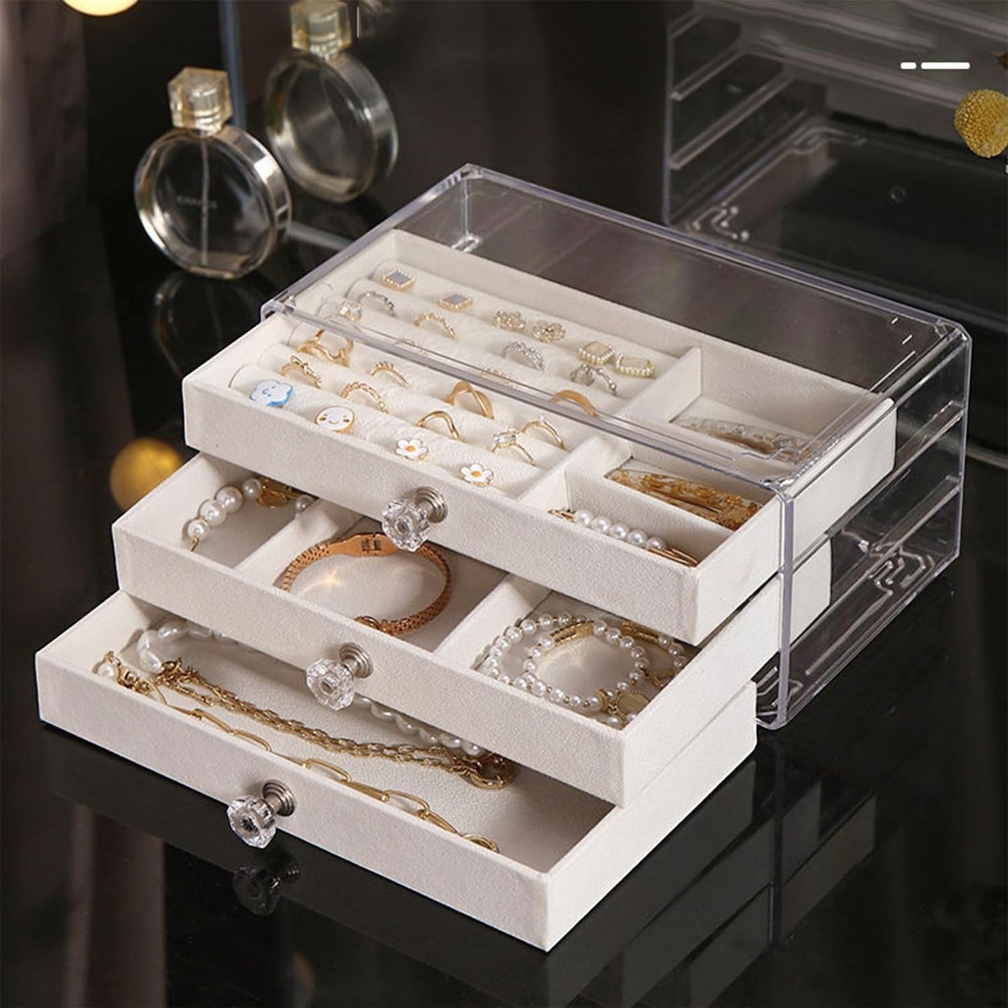 Waf Store Lebanon 3-drawer transparent acrylic jewelry box with soft cream velvet interior and crystal-style knobs.