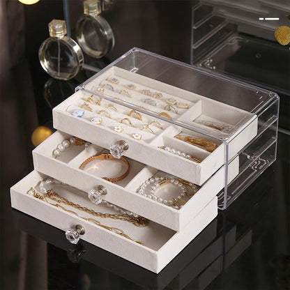 Waf Store Lebanon 3-drawer transparent acrylic jewelry box with soft cream velvet interior and crystal-style knobs.