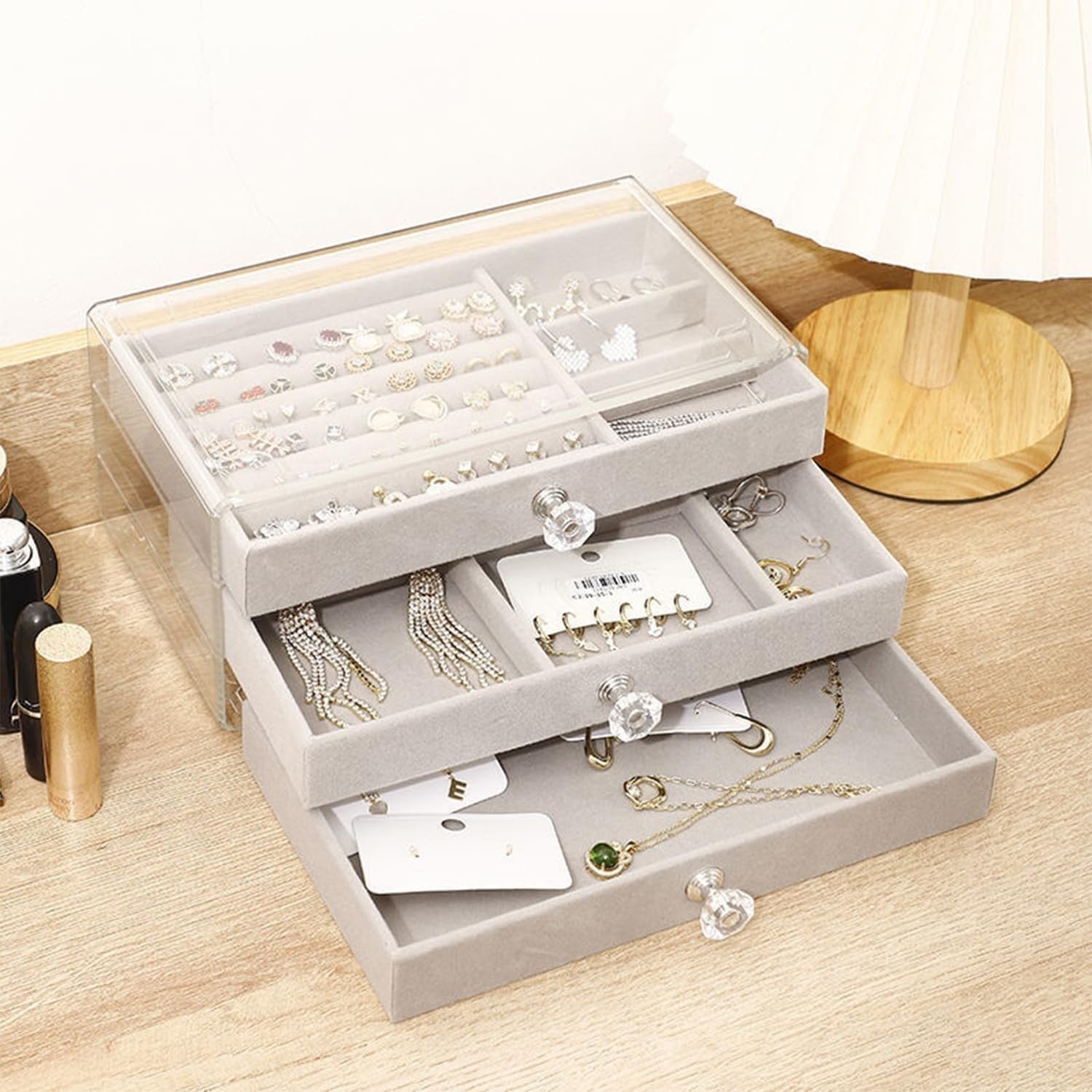 Waf Store Lebanon 3-drawer jewelry box in clear acrylic with soft grey velvet interior and crystal-style knobs.