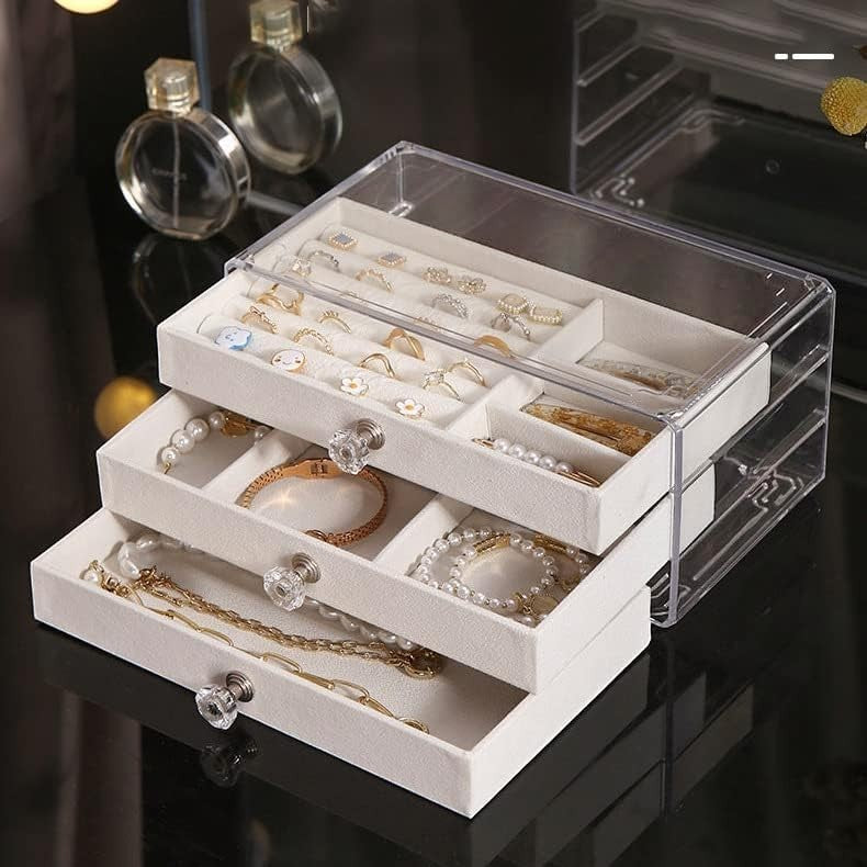 Waf Store Lebanon 3-drawer jewelry box in clear acrylic with soft beige velvet interior and crystal-style knobs.