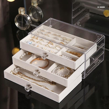 Waf Store Lebanon 3-drawer jewelry box in clear acrylic with soft beige velvet interior and crystal-style knobs.