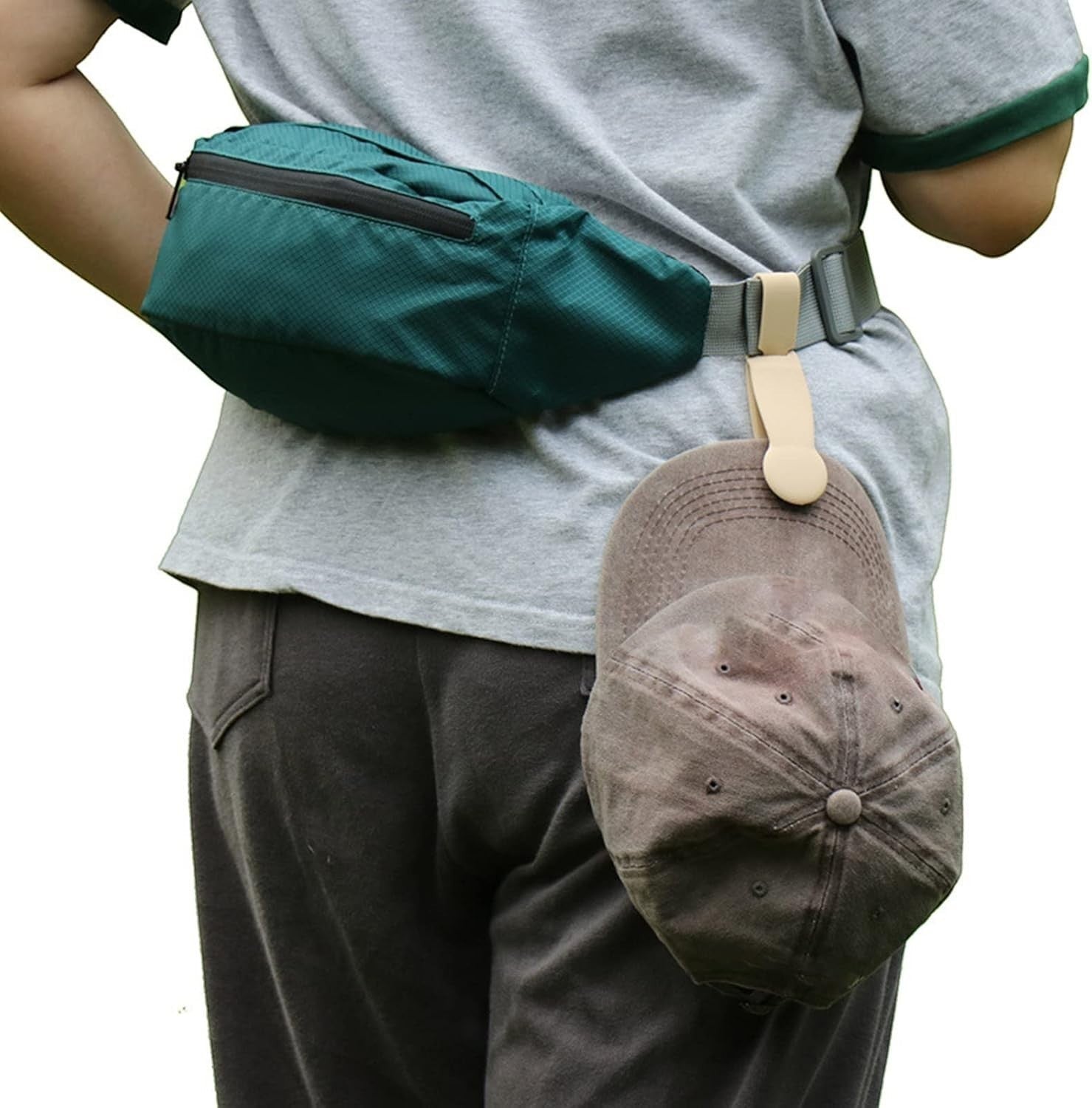 Waf Store Lebanon beige silicone hat clip attached to a belt loop holding a brown baseball cap on a person