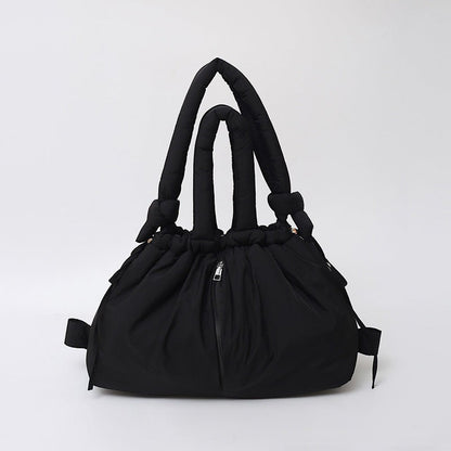 Waf Store Lebanon black nylon puffer tote bag with convertible straps, quilted design, and central zipper pocket.