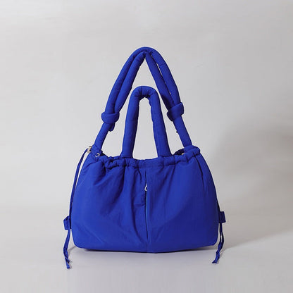Waf Store Lebanon royal blue nylon puffer tote bag with convertible shoulder straps and drawstring closure.