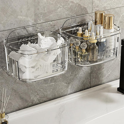 Waf Store Lebanon clear acrylic wall-mounted storage boxes holding toiletries and tissues on a grey tiled bathroom wall.