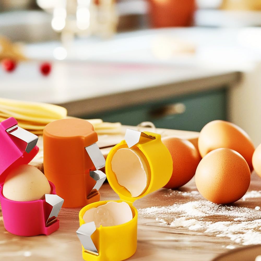 Waf Store Lebanon egg shell crackers in pink, orange, and yellow plastic with stainless steel blades on a kitchen table