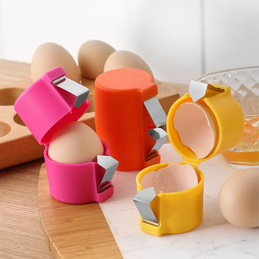 Waf Store Lebanon egg shell crackers in pink, orange, and yellow plastic with stainless steel blades on a kitchen board
