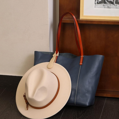 Waf Store Lebanon beige silicone magnetic hat clip attached to a blue leather tote bag holding a fedora hat