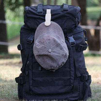 Waf Store Lebanon beige magnetic hat clip holding a grey baseball cap securely on a black outdoor backpack