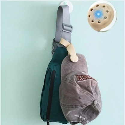 Waf Store Lebanon beige silicone magnetic hat clip attached to a backpack strap holding a grey baseball cap