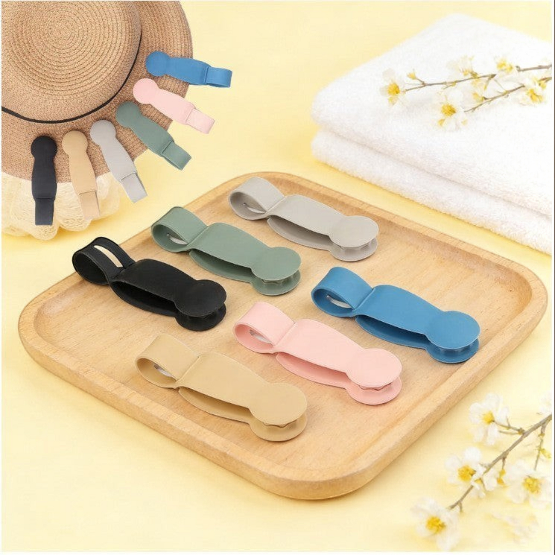 Waf Store Lebanon magnetic hat clips in assorted colors on a wooden tray with a straw hat and towel background