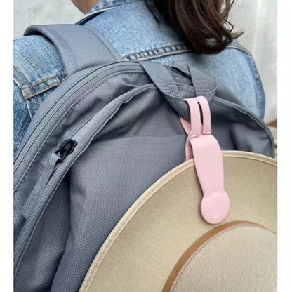 Waf Store Lebanon pink silicone magnetic hat clip attached to a grey backpack holding a beige hat