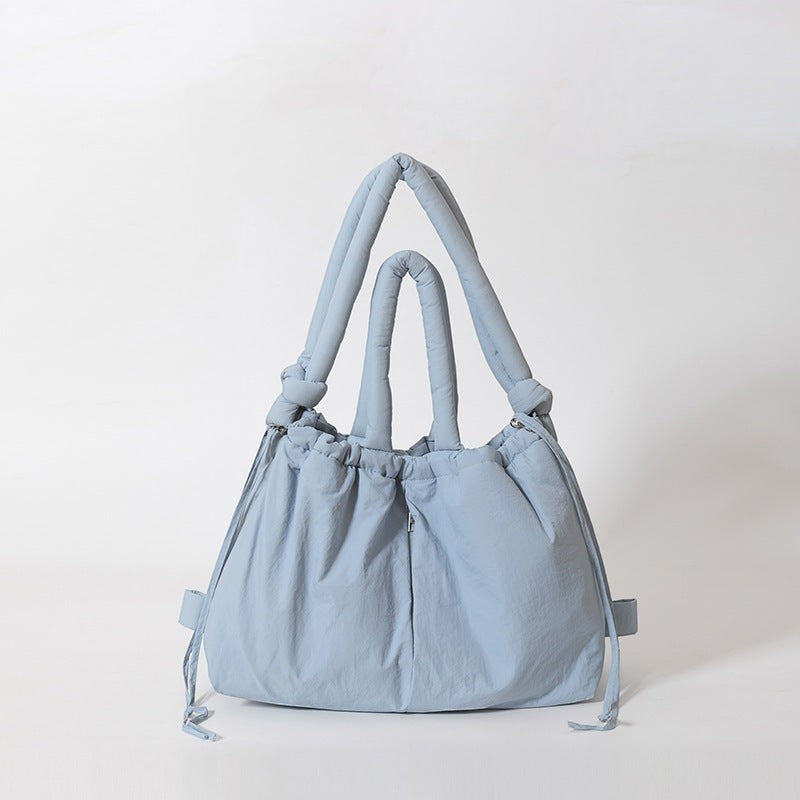 Waf Store Lebanon light blue nylon puffer tote bag that converts into a backpack with adjustable shoulder straps.