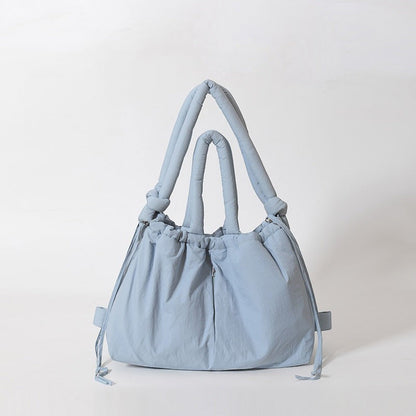 Waf Store Lebanon light blue nylon puffer tote bag that converts into a backpack with adjustable shoulder straps.