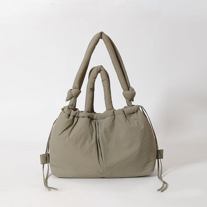 Waf Store Lebanon olive green nylon puffer tote bag with knotted handles and drawstring closure.