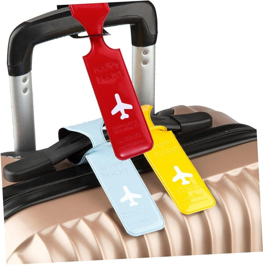 Waf Store Lebanon flexible PVC luggage tags in red, yellow, and light blue with airplane icons on a suitcase handle