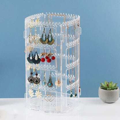 Waf Store Lebanon rotating clear acrylic jewelry organizer stand with hanging earrings and necklaces on a table.