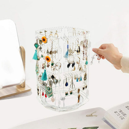 Waf Store Lebanon rotating clear acrylic jewelry organizer stand holding various earrings and necklaces on a desk