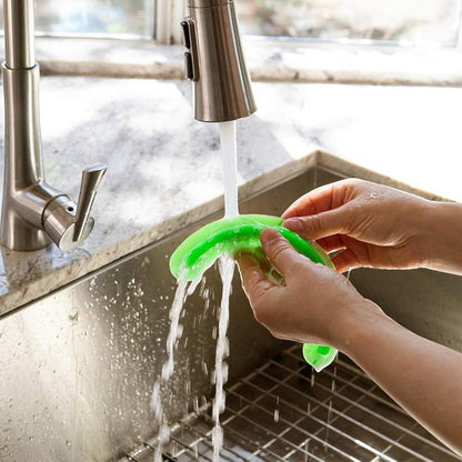 Waf Store Lebanon green silicone food separator being rinsed under a kitchen faucet for easy cleaning