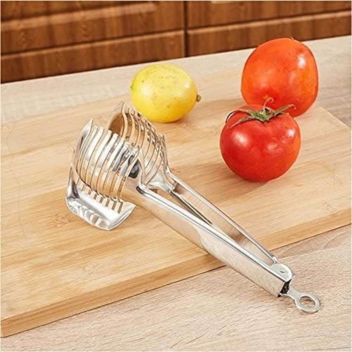 Waf Store Lebanon stainless steel lemon and tomato slicer with an ergonomic clamp design on a wooden cutting board.