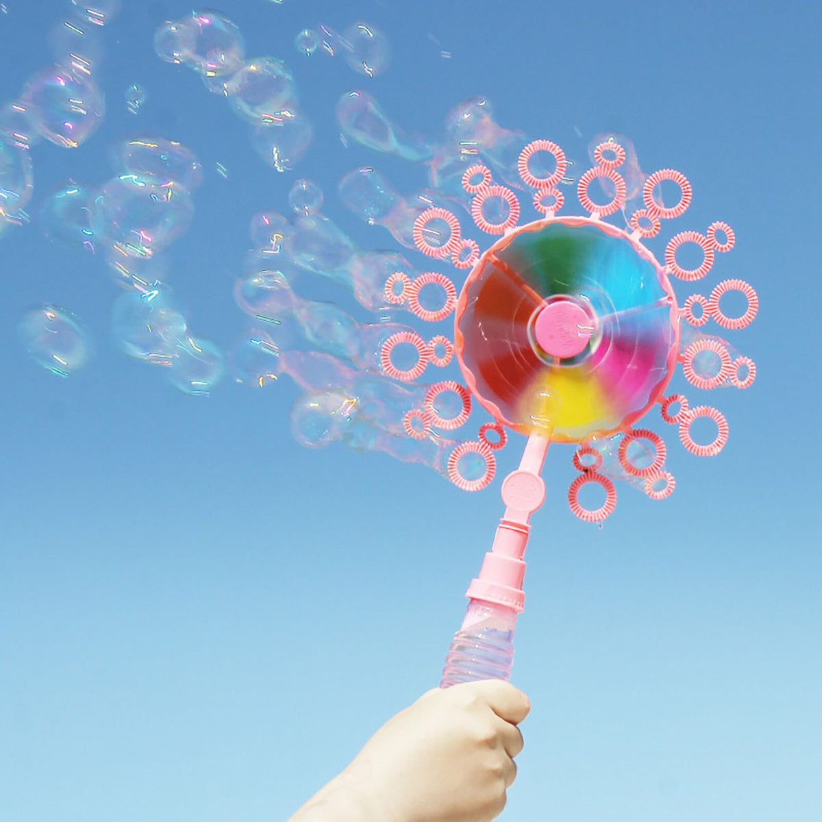 Windmill bubble blower with bubble solution in the handle